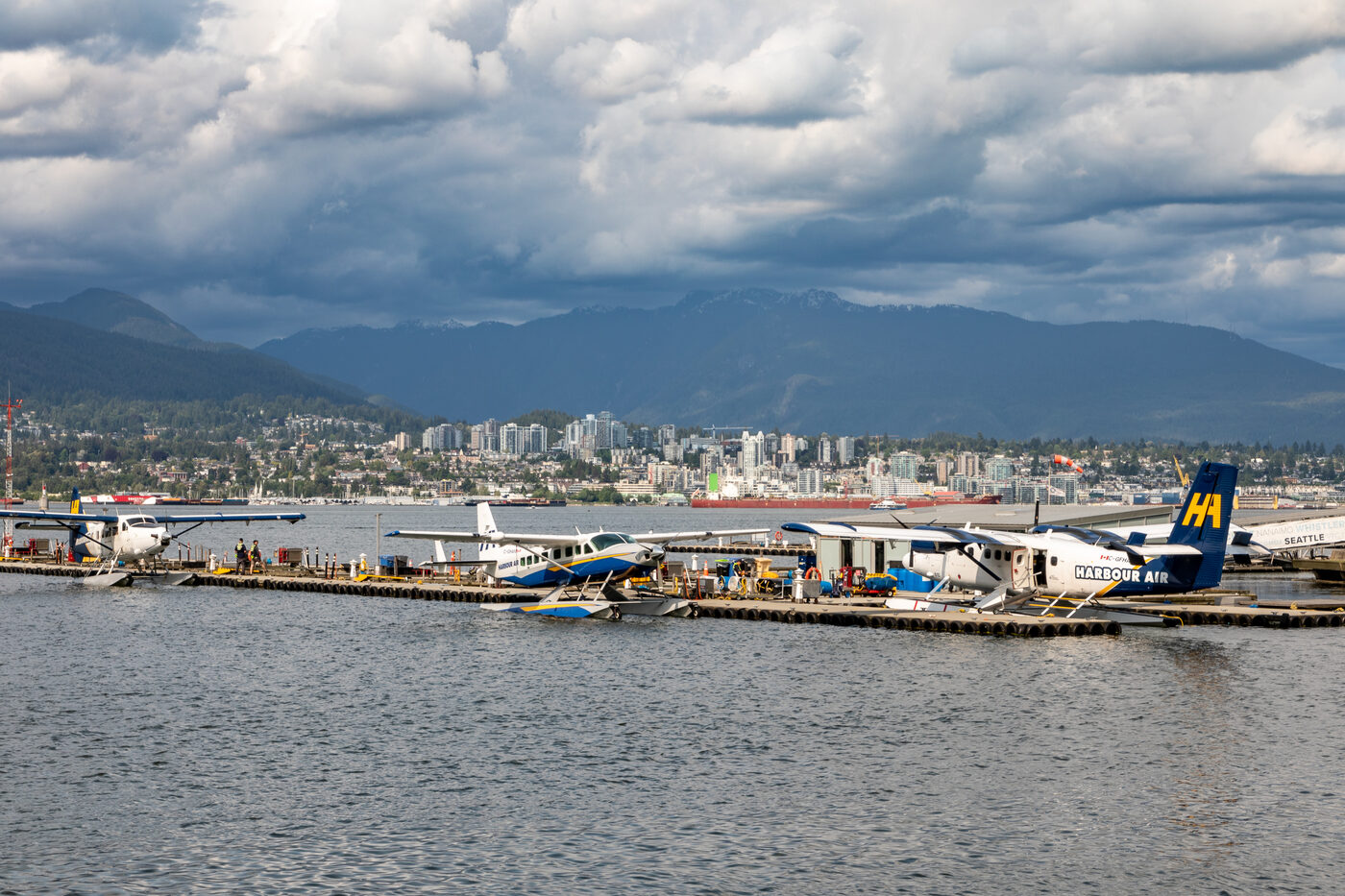Seaplanes docked on Burrard Inlet with mountains behind